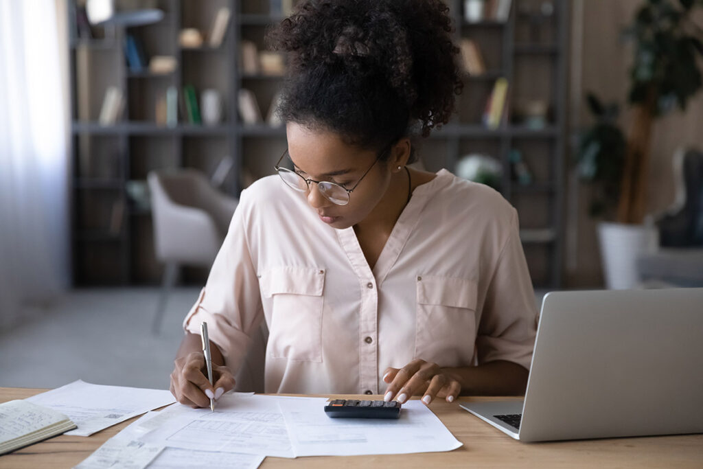 A young woman working at her desk.