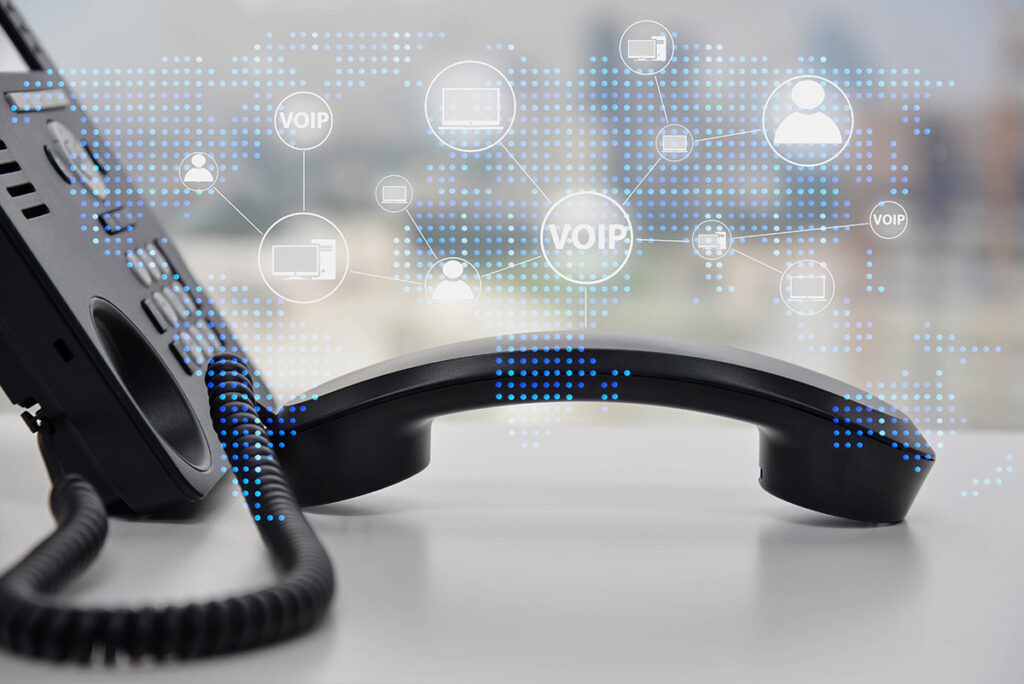 A voip phone resting on the table with all the things it can handle superimposed overtop.